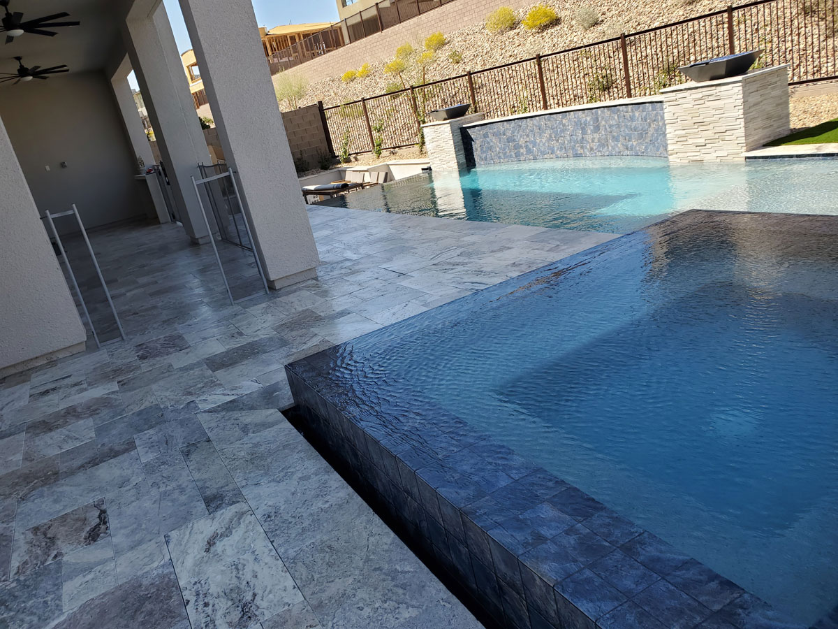 Modern residential backyard with pool and stone paver patio